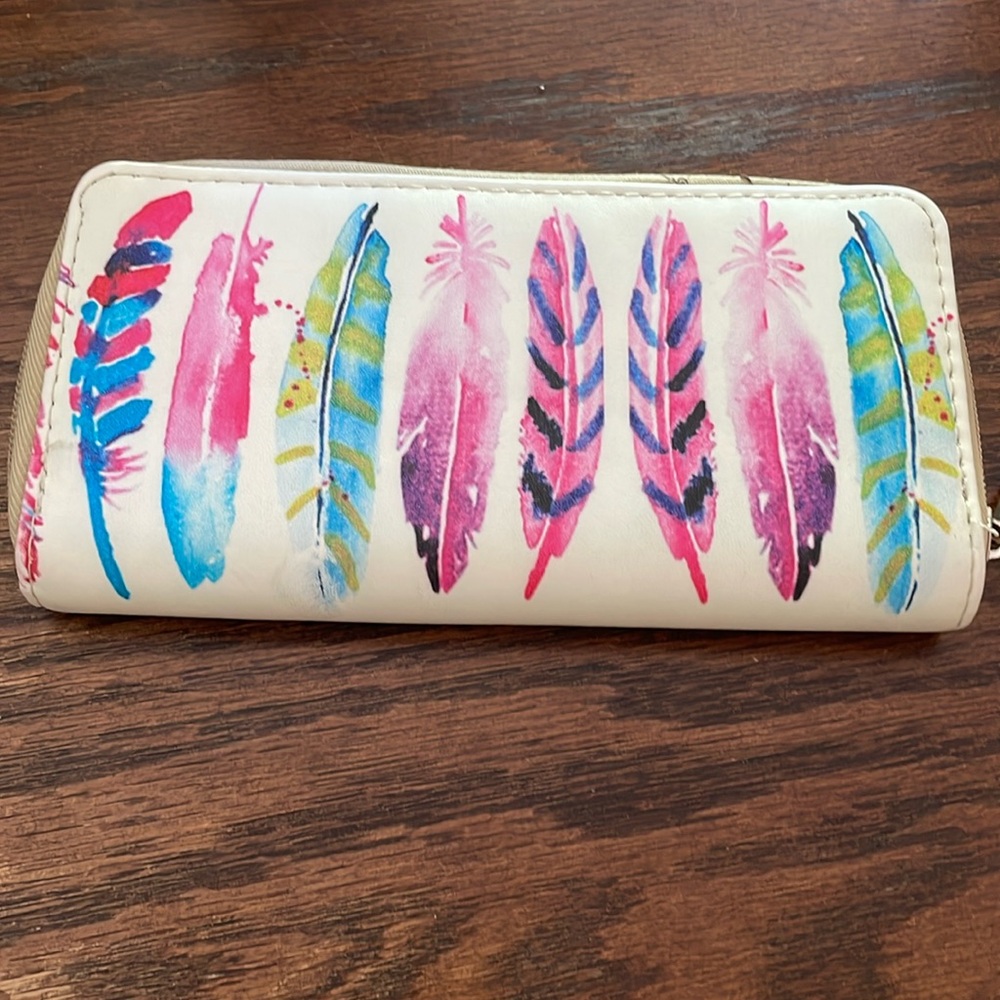 Darling Feather Wallet used but zips good,stitched up on the corner